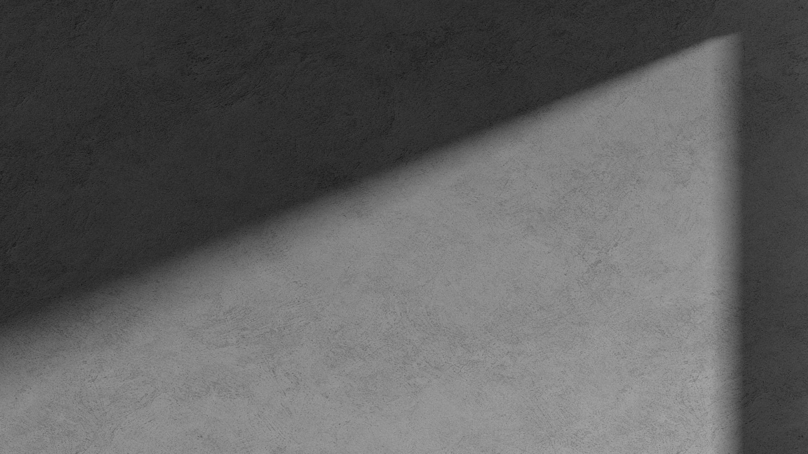 壁の角に落ちる斜めの光と影